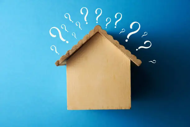 Photo of Real estate developer and managing property investment concept. houses with question mark on blue background