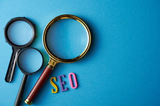 istock SEO words and three magnifying glass  on the Blue Background 1284898322