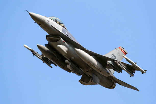 Armed US Air Force F-16C fighter jet plane from 480th Fighter Squadron taking off from Spangdahlem Air Base.