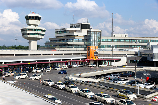 Airport tower and taxi s in front of the airport terminal of Berlin-Tegel airport. June 1, 2016