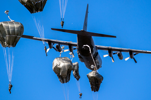 Group of military parachutist paratroopers jumping out of a transport plane during the Exercise Falcon Leap. September 21, 2019.