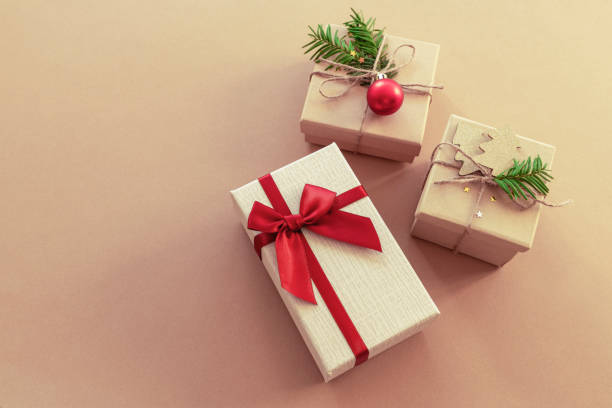 istock Three different gift boxes on beige background. Winter holidays concept. Top view, copy space 1284899933