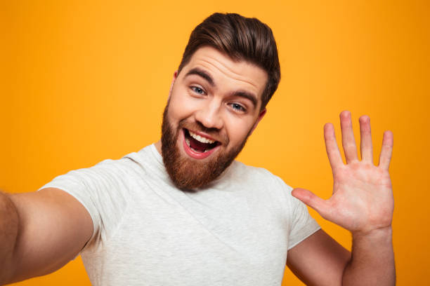 istock Portrait of a smiling bearded man waving 1284900201