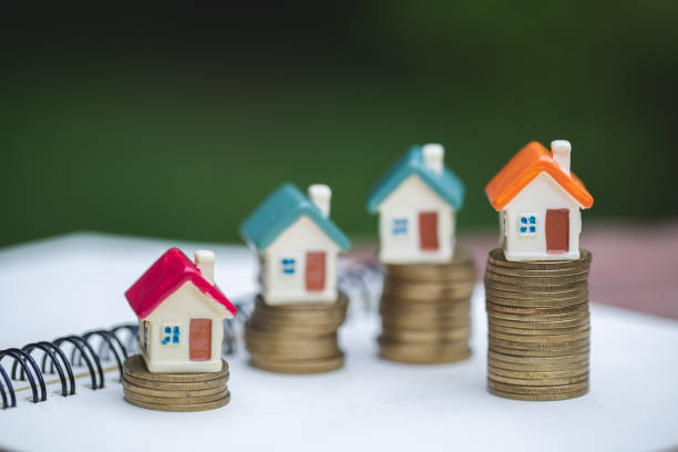 miniature colorful house on stack coins, finance and investment concept and real estate growth interest. - real estate imagens e fotografias de stock