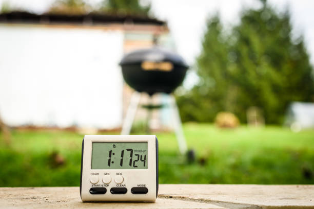 Metallic analog thermometer with clear display for measuring temperature, captured against a completely black background. Detailed shot showcasing the thermometer's scale and design in high contrast.