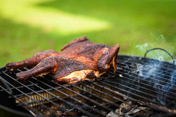 istock Traditional spatchcocked barbecue chicken al mattone on charcoal grill. 1284901963