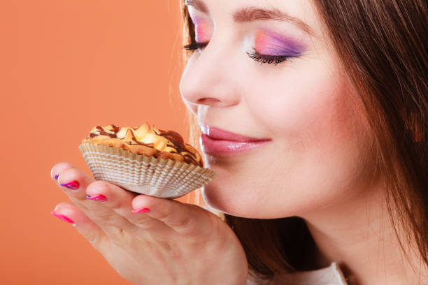 A woman enjoys a slice of delicious cake.