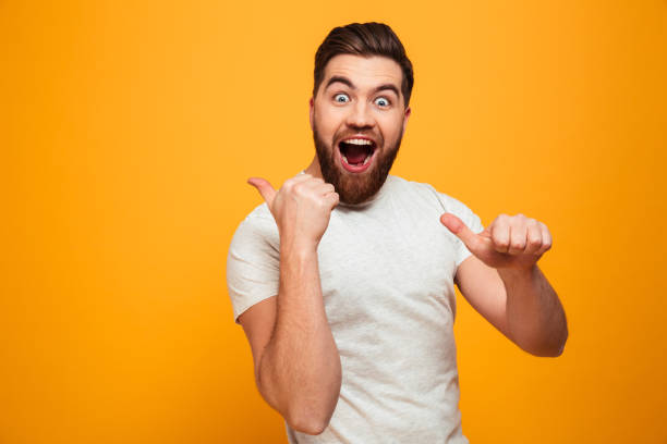 istock Portrait of a happy bearded man pointing 1284903269