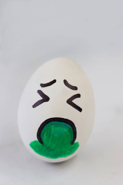 istock Image of cartoon face drawn on boiled egg expressing illness and vomiting 1284903853