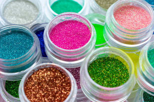 istock Trendy multicolored glitter in jars. Shimmer, sparkle for makeup, manicure. Shiny powder. Bright pigments. Cosmetic products. Vibrant eye shadow. Blue, pink, green, red. 1284905127