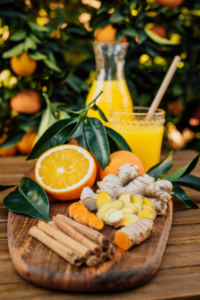 istock Sliced turmeric and ginger root with cinnamon sticks and freshly squeezed orange juice of untreated Bio oranges from the own garden 1284905152