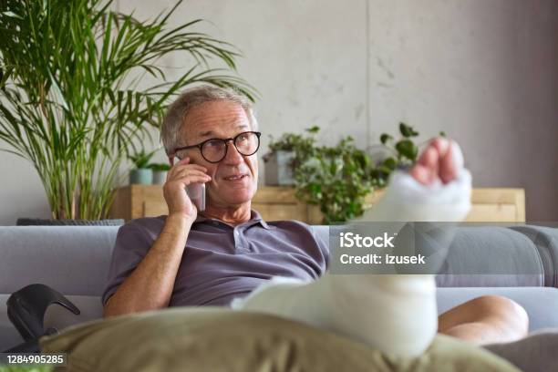 Senior Man With Broken Leg At Home Stock Photo - Download Image Now - Recovery, Domestic Life, 65-69 Years