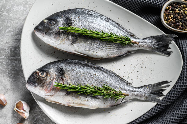istock Fresh sea bream fish ready for cooking. Gray background. top view. 1284906158