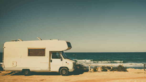 istock Camper car on beach, camping on nature 1284906845
