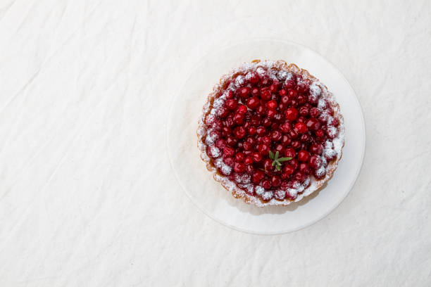 istock Lingonberry tart on a light cloth background. Top view 1284906905