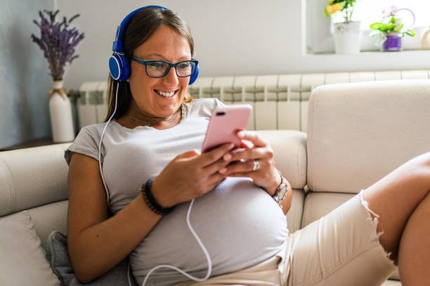 istock Pregnant woman using smart phone 1284907685