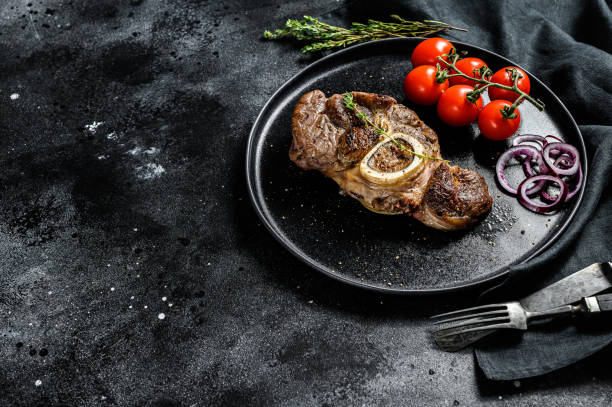 istock Osso buco, cooked Veal shank. Ossobuco meat. Black background. Top view. Copy space 1284907753