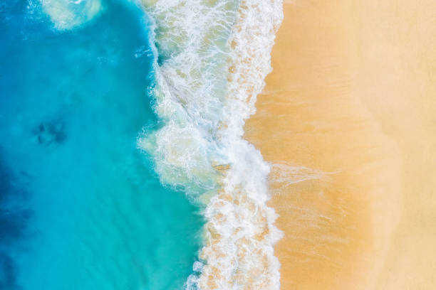 istock Beach and large ocean waves. Coast as a background from top view. Blue water background from drone. Summer seascape from air. Travel image 1284908429