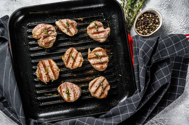 Tender boneless grilled pork chops. steak tenderloin. gray background. Top view