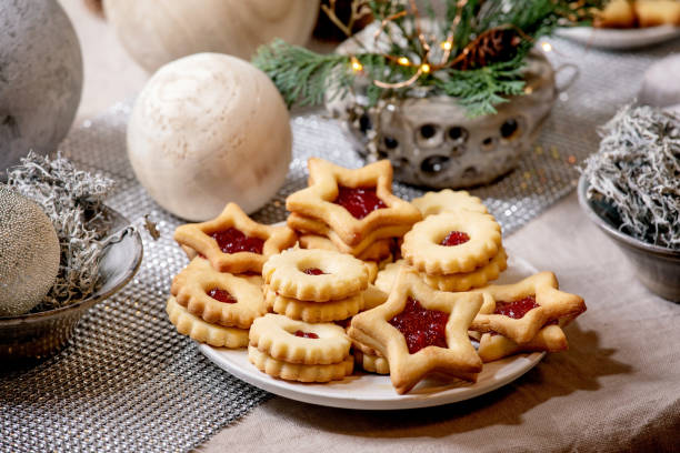 istock Christmas Linz shortbread biscuits cookies with wooden decorations on xmas table 1284909737