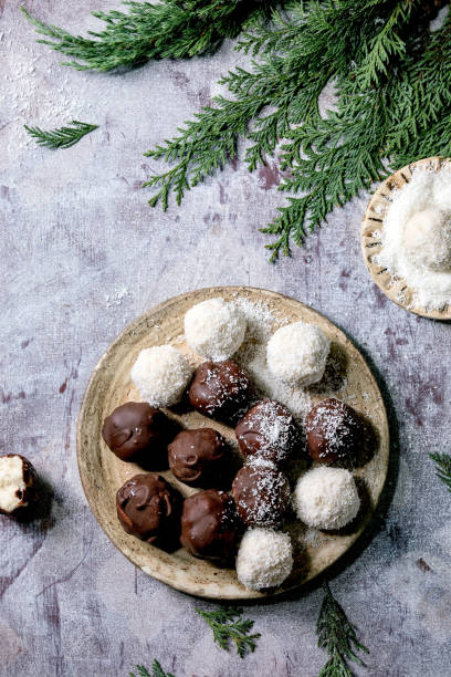istock Raw vegan coconut chocolate candy balls over white. Flat lay 1284909779