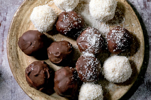 istock Raw vegan coconut chocolate candy balls over white. Flat lay 1284909782