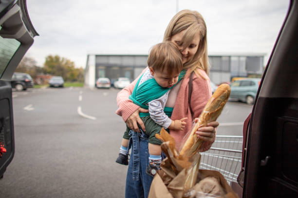 istock Single mother at grocery shopping with baby 1284910519