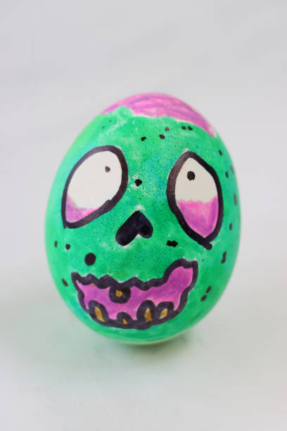 istock Image of cartoon face drawn on boiled egg, egg decorated as zombie monster 1284910916