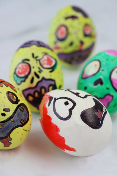 istock Image of eggs decorated as cartoon monsters capturing egg with drawn scared face, zombie apocalypse pursuit concept, eating brains 1284911131