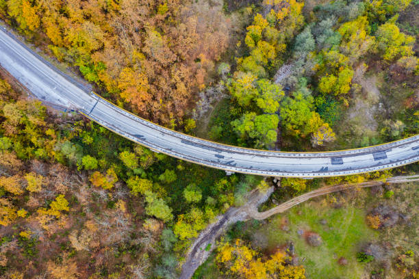 istock Drone aerial view of a curved road 1284912057