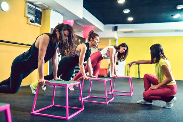 istock Female Fitness Instructor Working With Students On Cardiovascular Endurance 1284913416