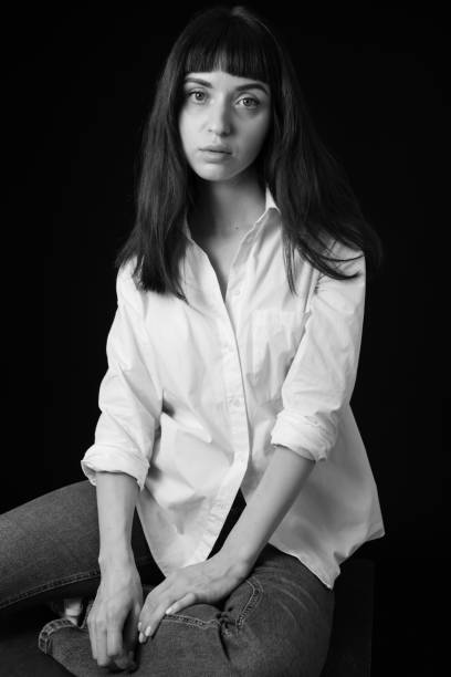 istock Studio portrait of a young woman against plain black background 1284913808