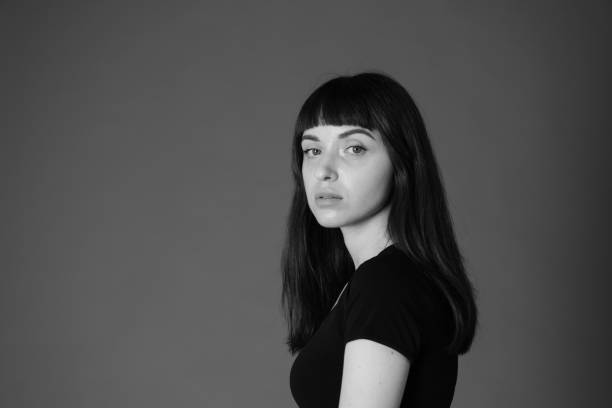 istock Studio portrait of a young woman against plain black background 1284913836