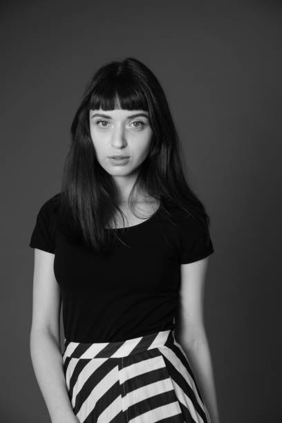 istock Studio portrait of a young woman against plain black background 1284913841