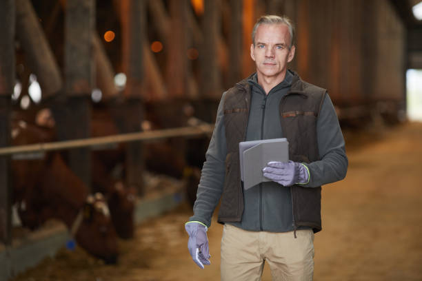 istock Modern Mature Man Holding Tablet at Farm 1284913970