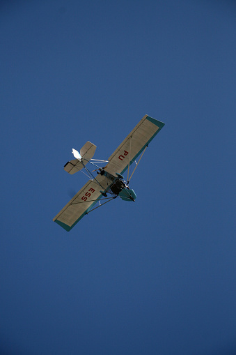 porto seguro, bahia / brazil - february 6, 2008: experimental ultralight plane is seen during flight in the sky in the city of Porto Seguro, in the south of Bahia.