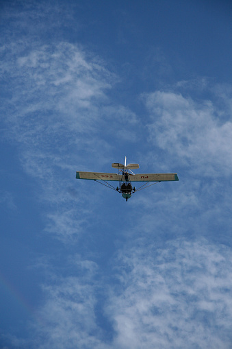 porto seguro, bahia / brazil - february 6, 2008: experimental ultralight plane is seen during flight in the sky in the city of Porto Seguro, in the south of Bahia.