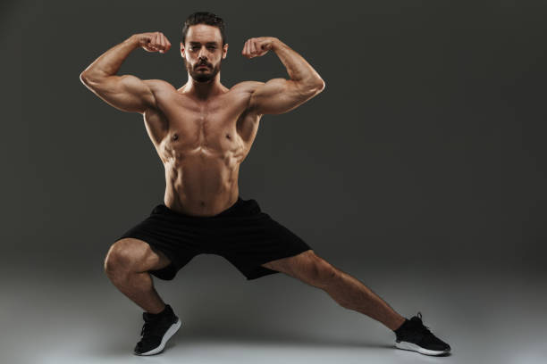 istock Portrait of a fit muscular bodybuilder flexing biceps 1284916355