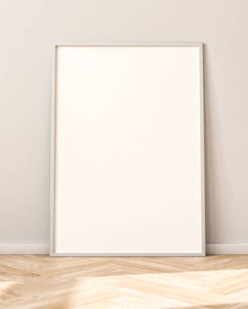 istock Empty Picture Frame on parquet floor leaning against bright wall. Sunlight flooding in from the left. 1284917014
