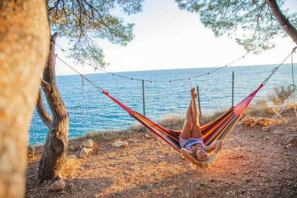 istock Woman lying in hammock in seaside 1284917580