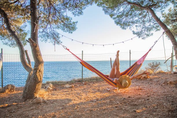 istock Woman lying in hammock in seaside 1284917611