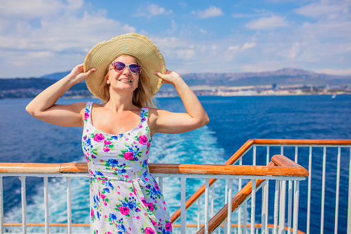 Blonde woman relaxing on cruise ship on summer day