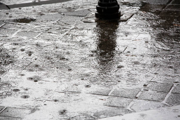 istock falling rain drops on the street 1284921960