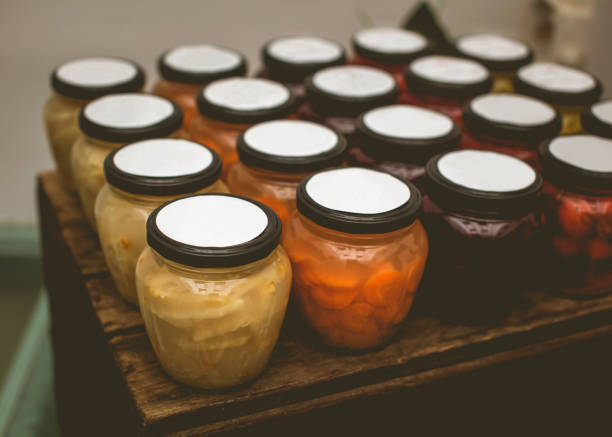 A group of symmetrically arranged jars of pickled vegetables arranged in rows