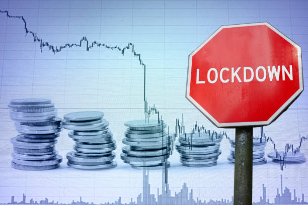 istock Lockdown sign on economy background - graph and coins. Lockdown because of coronavirus. Global economic crisis, recession. 1284922954