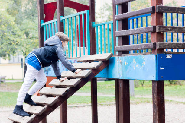 istock Small boy playing alone on the playground due to coronavirus pandemic. 1284923784