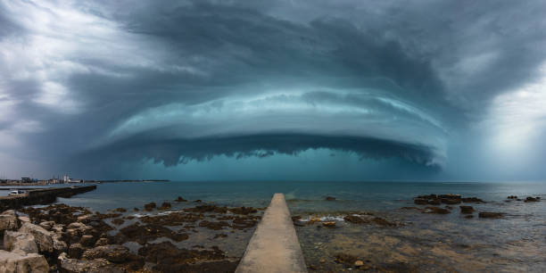 istock Panoramic Sea Storm with Pier Toward the Storm 1284924926