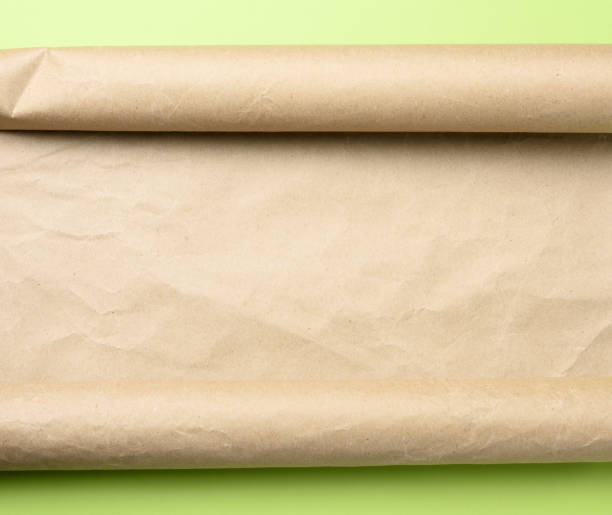 istock roll of brown parchment paper on a green background, 1284925796