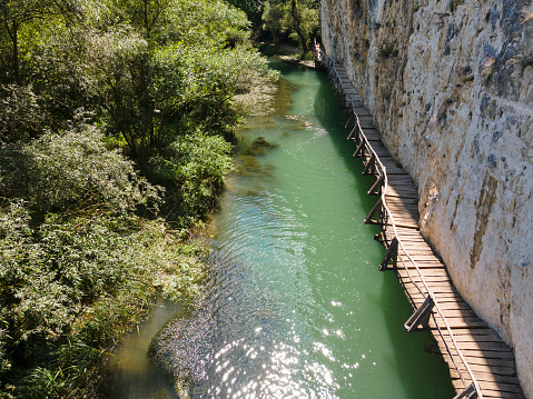 El Caminito del Rey is a walkway pinned along the steep walls of a narrow gorge in El Chorro, near Ardales in the province of Málaga, Spain. The name derives from the original name of Camino del Rey (King's Pathway). The walkway had fallen into disrepair and was partially closed for over a decade. After four years of extensive repairs and renovations, it re-opened in 2015. It has been known in the past as the \