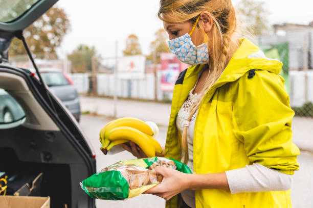 istock Young Adult Female Loading Groceries in Car 1284929286
